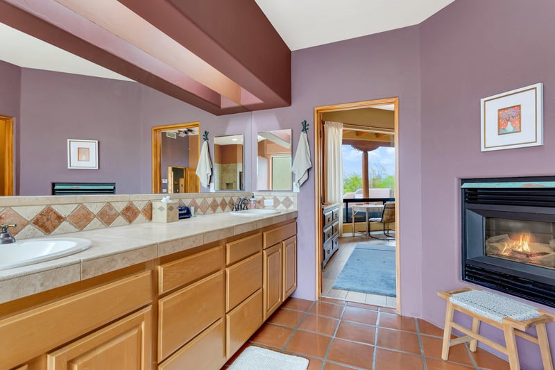 dual sinks and fireplace at master bathroom