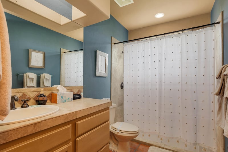 guest bathroom with showertub combo
