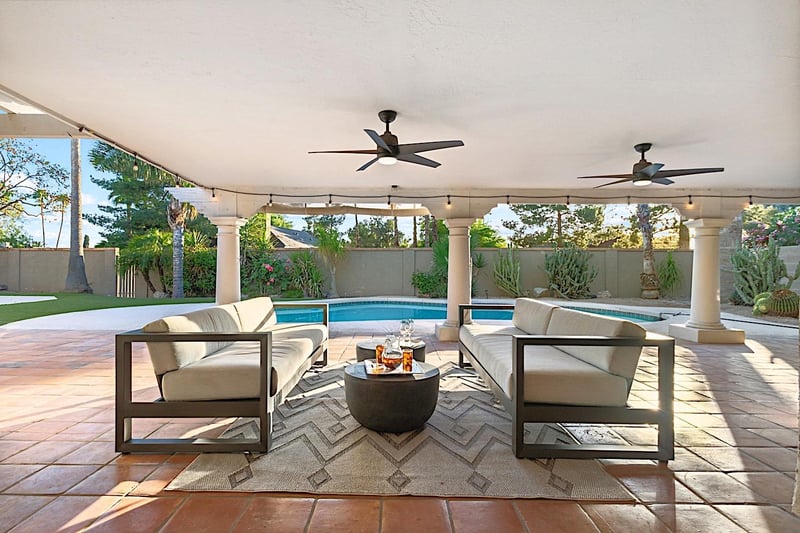 Outdoor sitting area w table and ceiling fans for a nice breeze