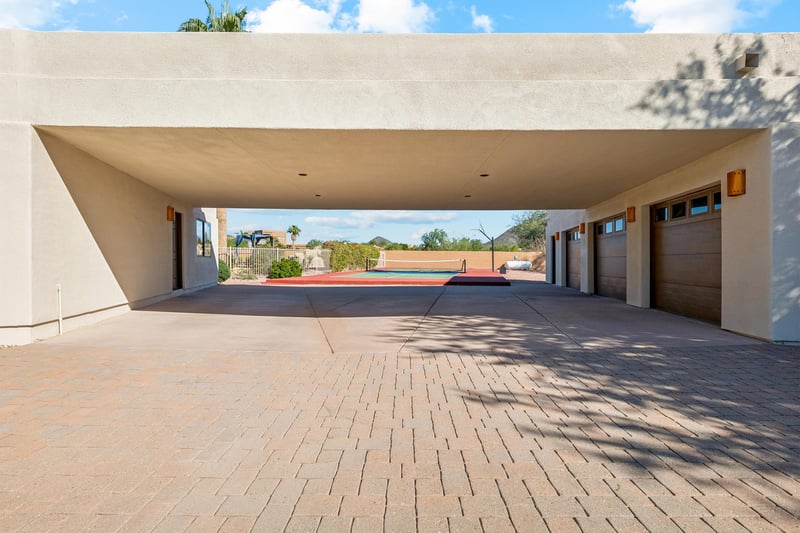 Wide open driveway between the house and garage,