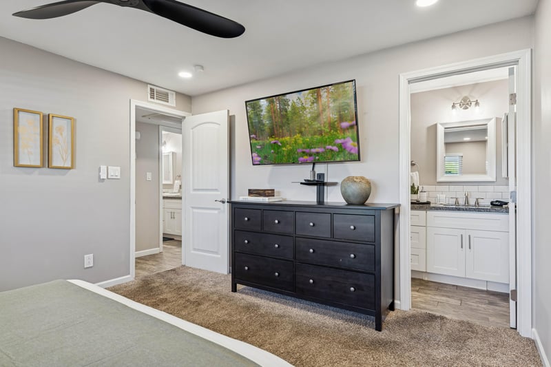 Primary bedroom with large size smart tv.