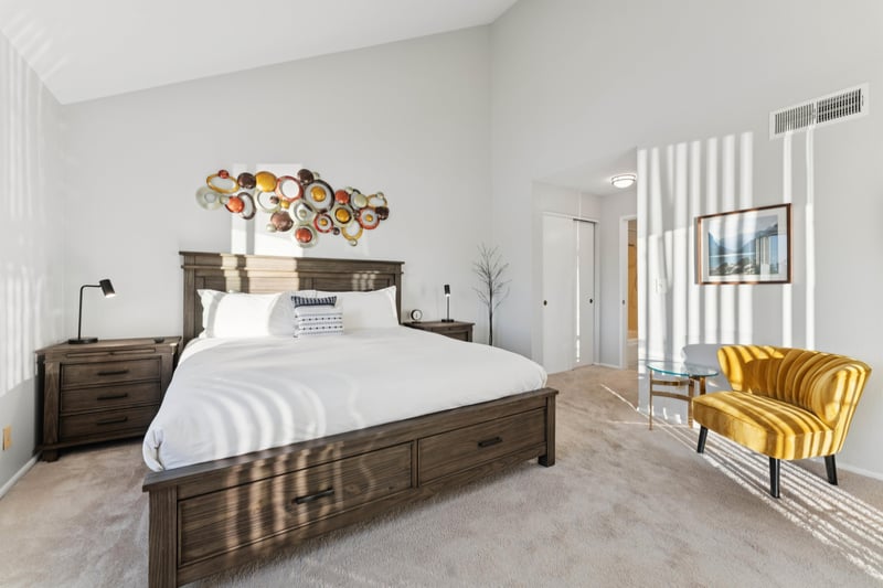 Beautifully decorated main bedroom featuring a king bed, two closets, and a private ensuite bathroom