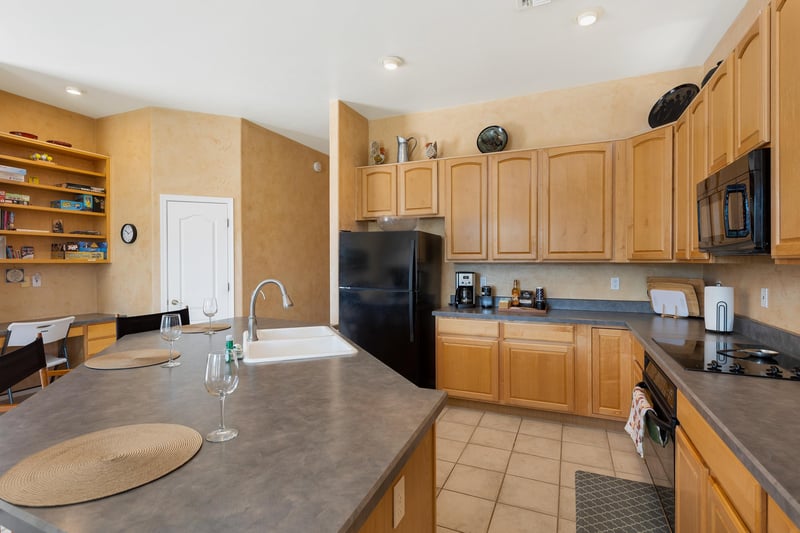 Kitchen with oak cabinets and black appliances