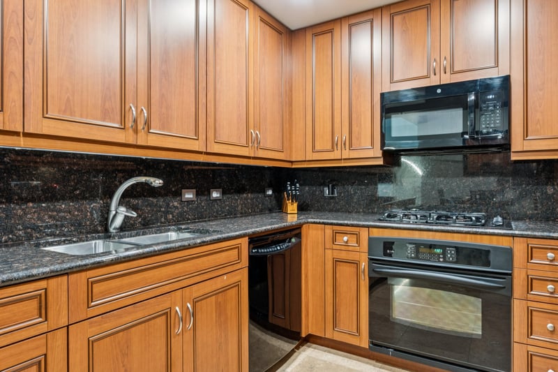 Gas stove top, with microwave oven, and dishwasher.