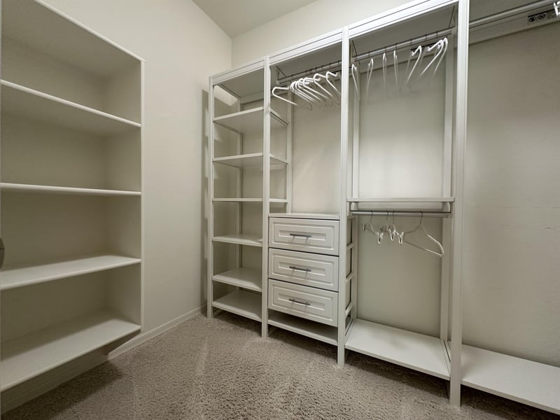 Large walk in closet with plenty of room to place your personal items.