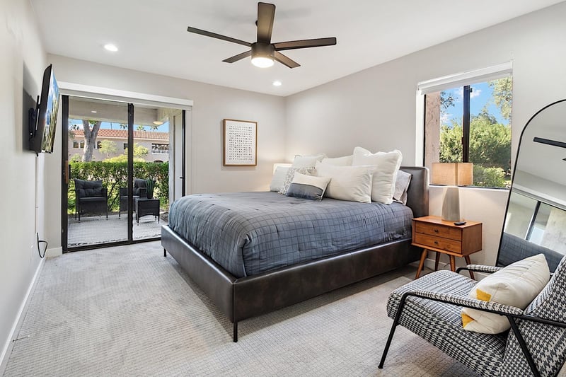 Master bedroom w king sized bed and mounted 55 Smart TV