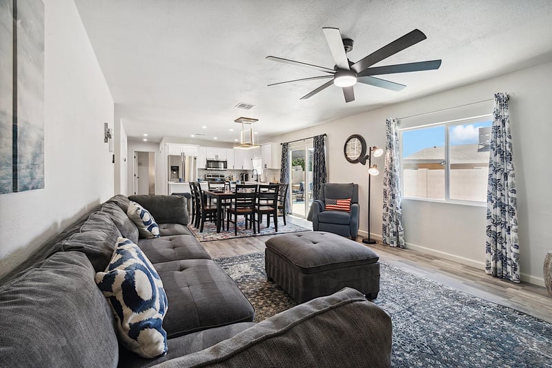 Living room has large sectional sofa, ottoman and reclining chair
