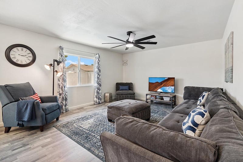 Living room has large sectional sofa, ottoman and reclining chair