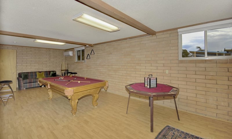 Downstairs game room with billiards and poker tables