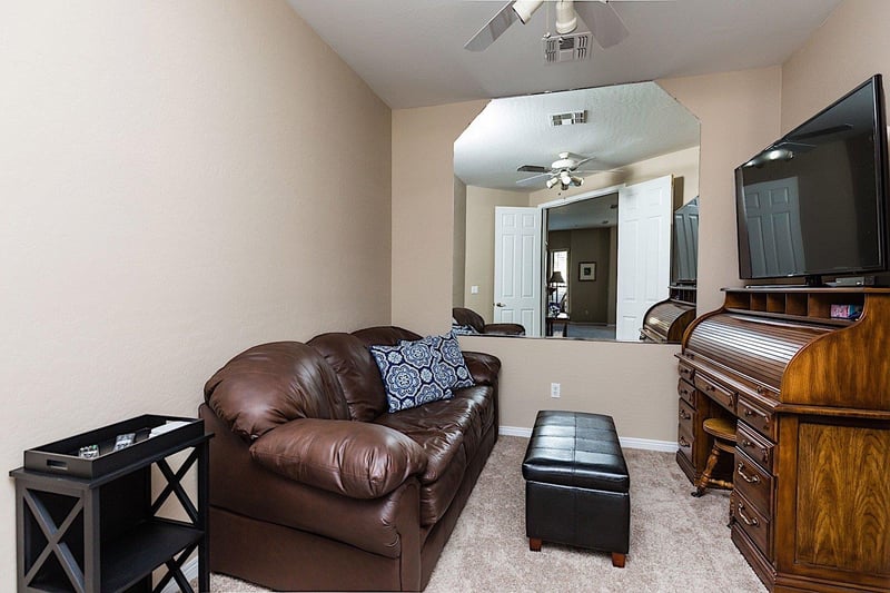 Den area with 55 TV with cable.  Tons of DVDs to choose from in the ottoman