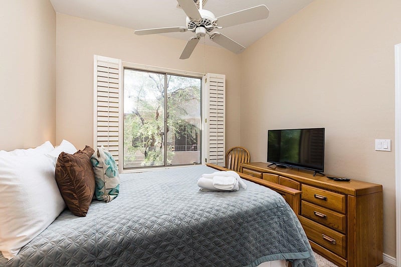 Guest bedroom has a queen bed and flat screen TV