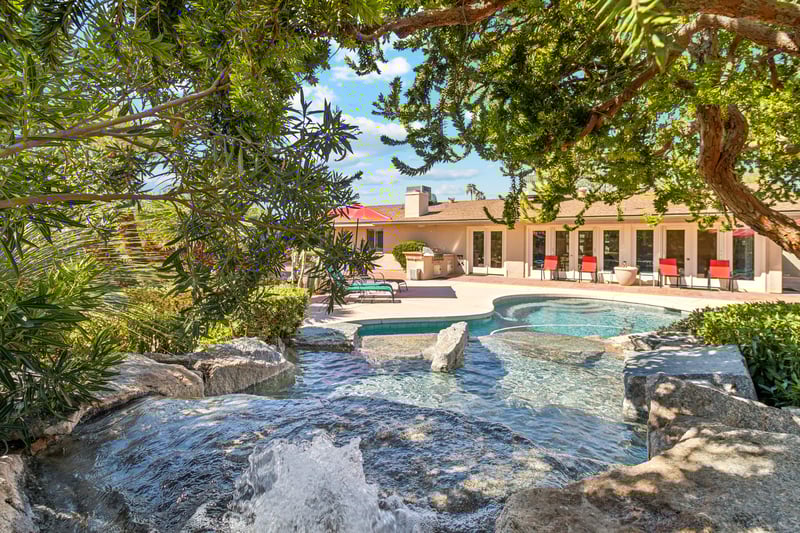 Resort style heated optional pool with tranquil waterfall.