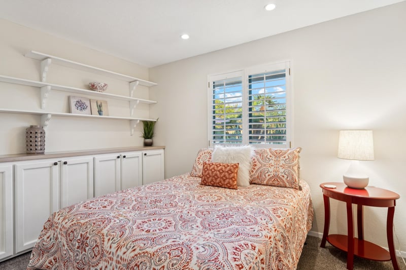 The cozy second bedroom has a calming ambiance with a desk built into the closet Perfect for those working from home