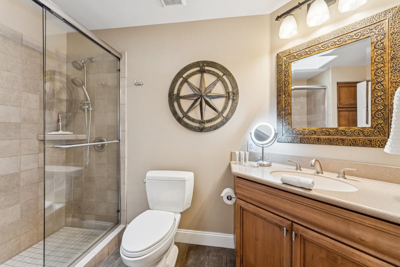 Bright hallway bathroom with dual shower heads and a convenient makeup mirror