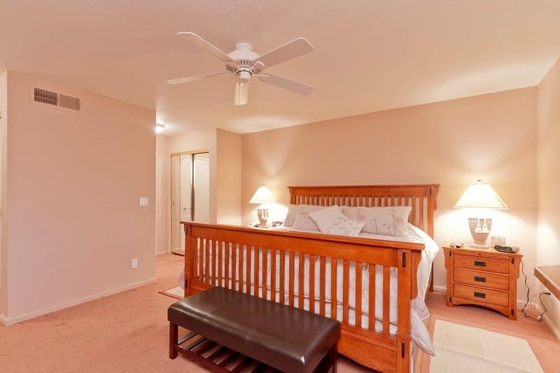 Master bedroom with plush king size bed, all in classic mission style.