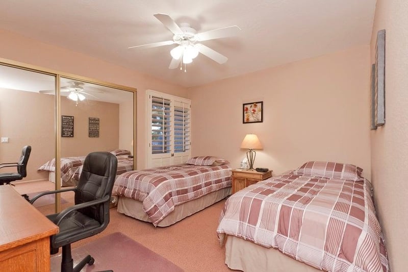 2nd bedroom has 2 twin beds and a desk.
