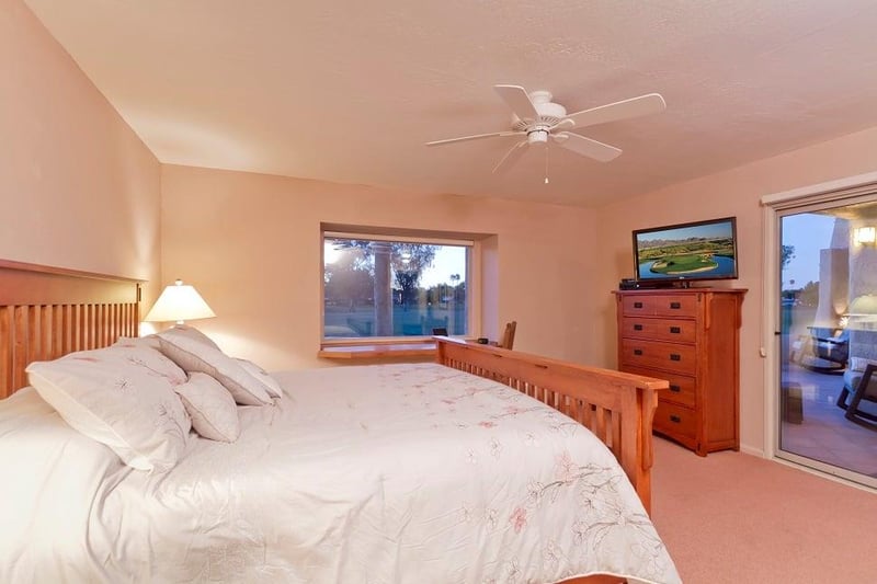 Master bedroom with mission style furniture and private access to the patio.