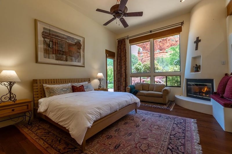 Master Bedroom With Access to Backyard and Fireplace