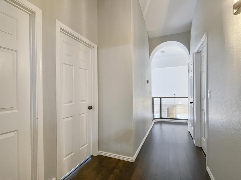 A bathroom, two bedrooms and the study loft are located off of this hallway