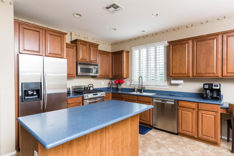 Island, stainless steel appliances and a deep kitchen sink.