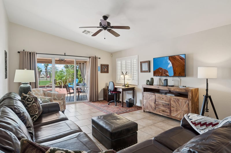 Spacious living room featuring a cozy sectional and dedicated workspace. Perfect for relaxation or working remotely