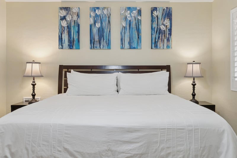 Main bedroom features a plush king bed