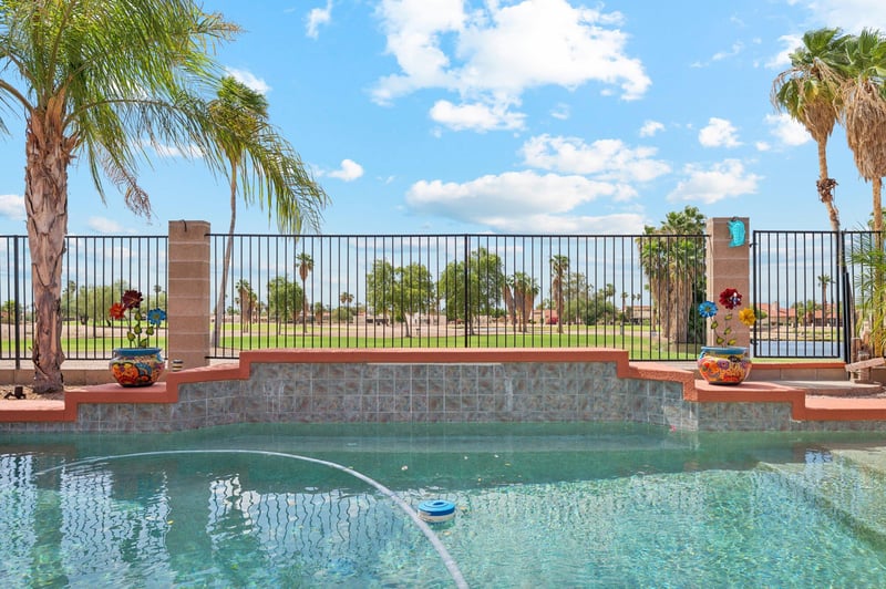 Sparkling pool with open views overlooking the golf course