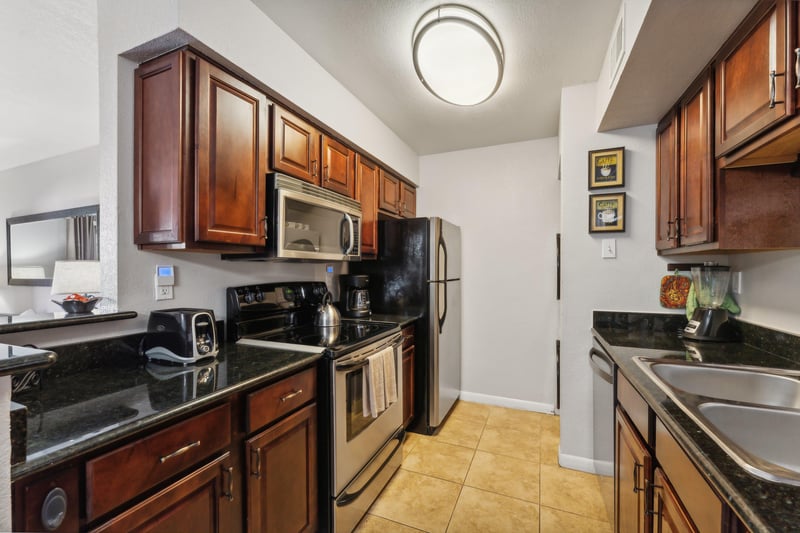 Well appointed galley kitchen with stacked laundry unit