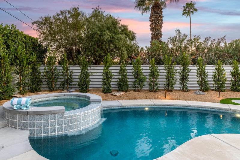 Integrated spa and pool with waterfall feature