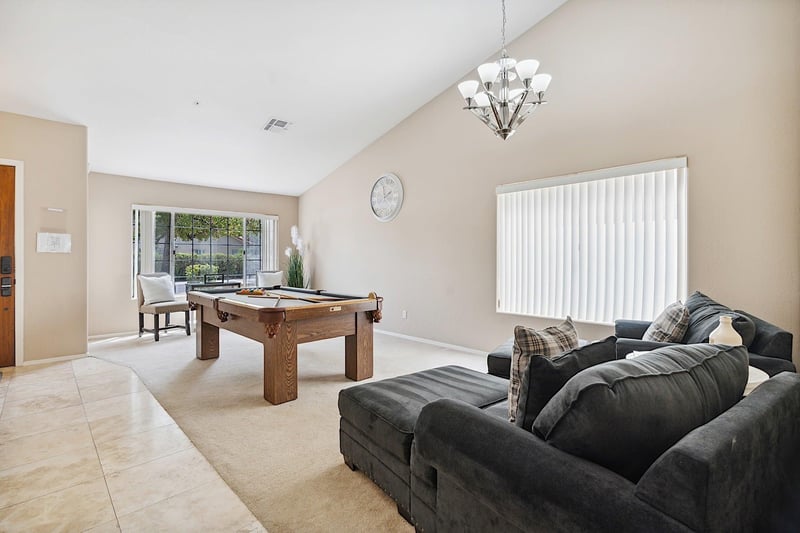 Family room has a billiard table and two oversized chairs