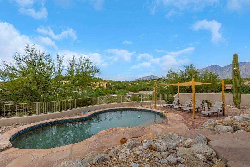 Pool with lounging chairs on the mountain side.