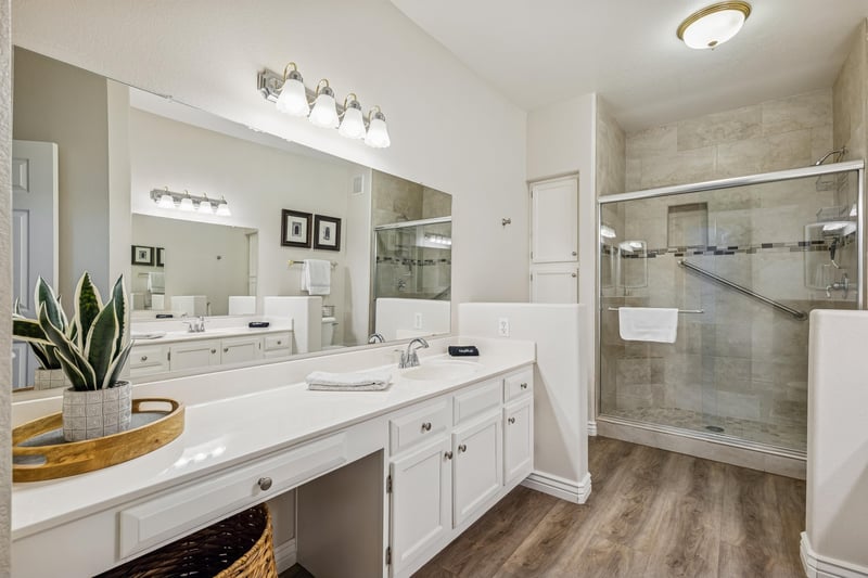 Primary bathroom with walk in shower and dual sinks.