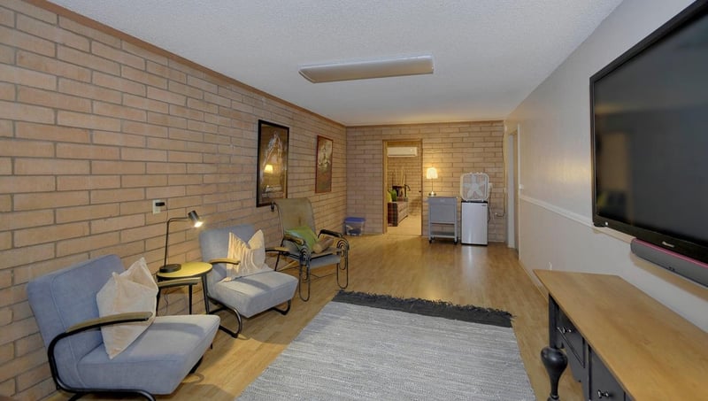 Movie room with huge TV and mini fridge