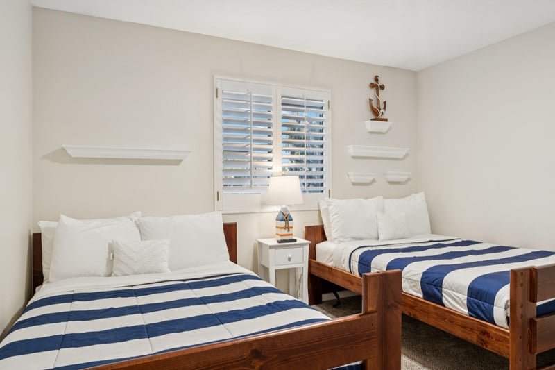Two full sized beds with sturdy wooden bed frames and a shuttered window for when you wanna let in a little AZ sunshine