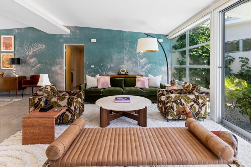 Beautiful living room that looks out to the pool and spa. Featuring a fireplace, sliding doors, and openconcept living.