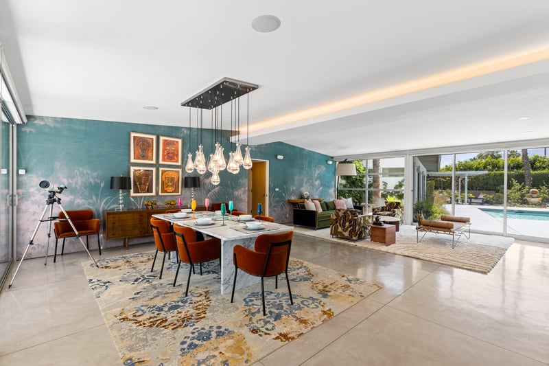 Dine at a marble table set for 6 under a beautiful chandelier.
