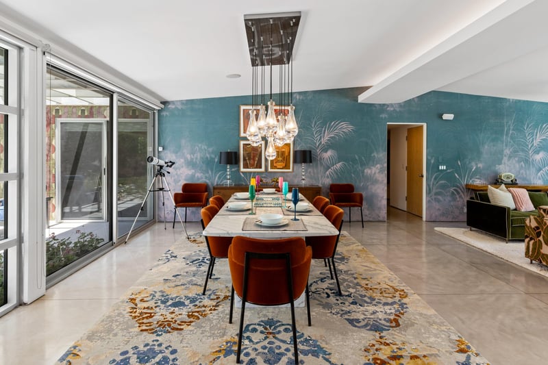 Dine at a marble table set for 6 under a beautiful chandelier.