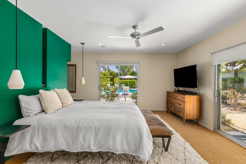 Features a queen size bed, sliding doors that access the poolspa and back patio, smart TV, and ensuite bathroom.
