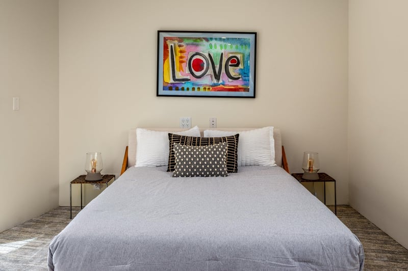Features a queen size bed, own sitting area, smart TV, patio access, and ensuite bathroom.