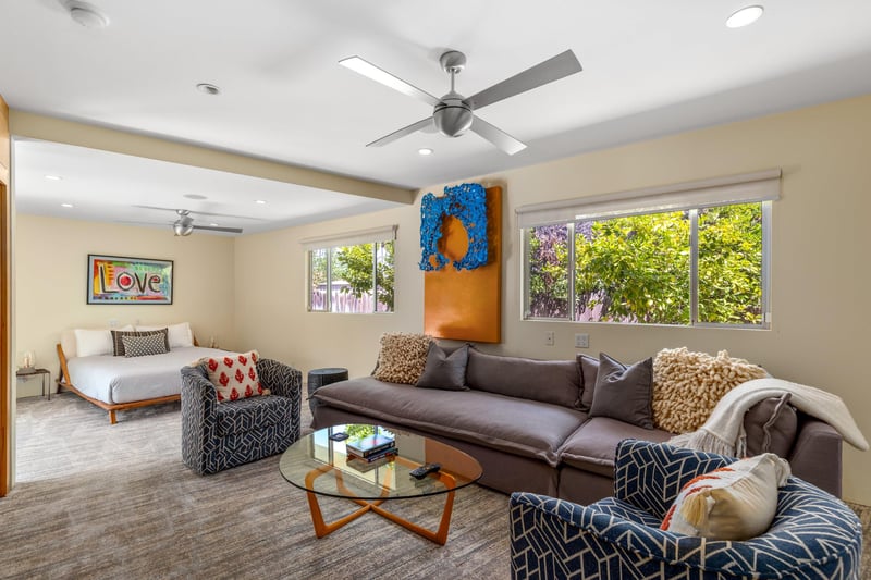 Features a queen size bed, own sitting area, smart TV, patio access, and ensuite bathroom.