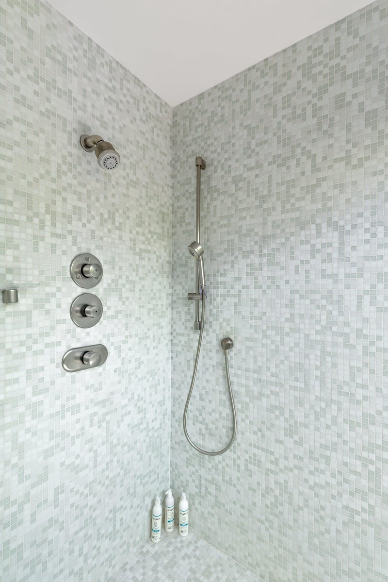 Standalone shower with its own sliding door to turn it into an indooroutdoor shower.