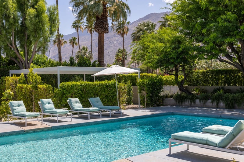 Private poolspa with sun loungers and umbrellas.