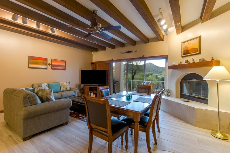 Features a smart TV, woodburning fireplace, and access to the patio.