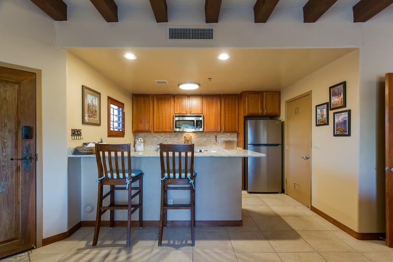 Features bartop counter seating for 2 guests, stainless steel appliances, keurig coffee maker, and kitchen essentials.
