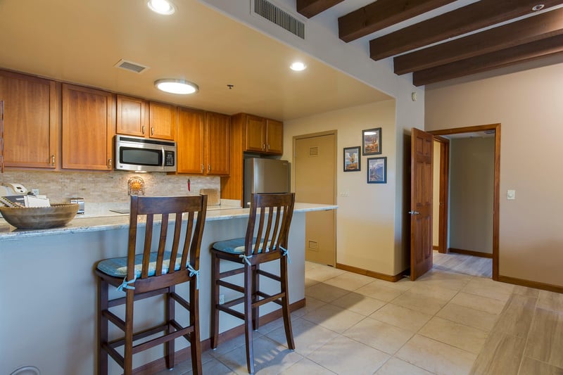 Features bartop counter seating for 2 guests, stainless steel appliances, keurig coffee maker, and kitchen essentials.