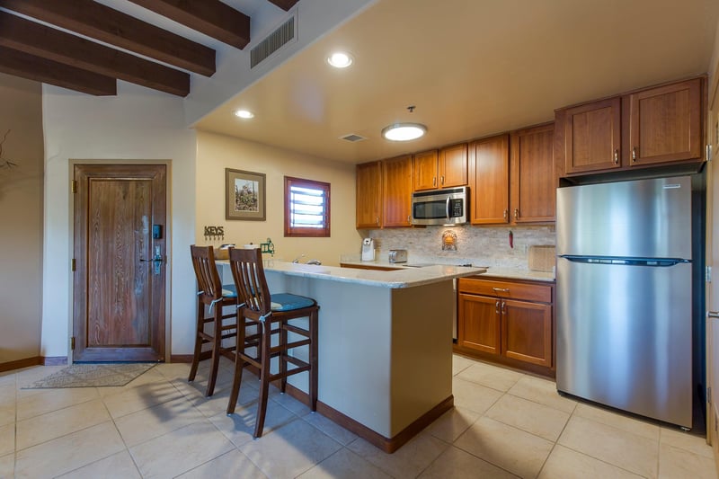 Features bartop counter seating for 2 guests, stainless steel appliances, keurig coffee maker, and kitchen essentials.