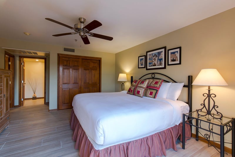 King size bed, desk, ceiling fan, and direct patio access.