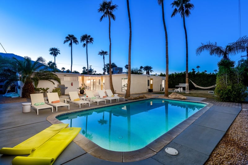 Pebble finish heated pool with an entertainers yard