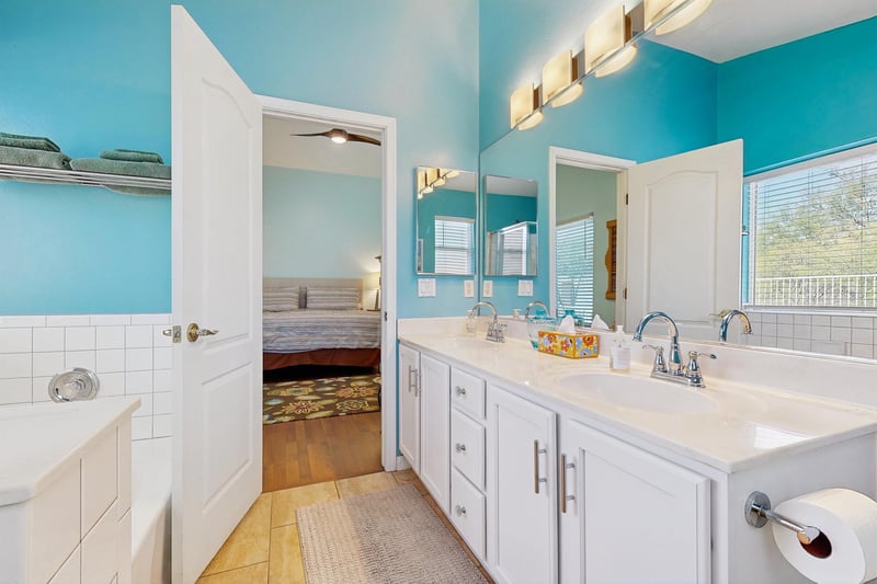 Ensuite bathroom features a stand alone tub, stand alone shower, dual vanity sinks, and counter space.