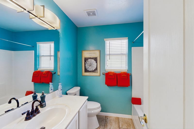 Features a showertub combo and cabinet space.